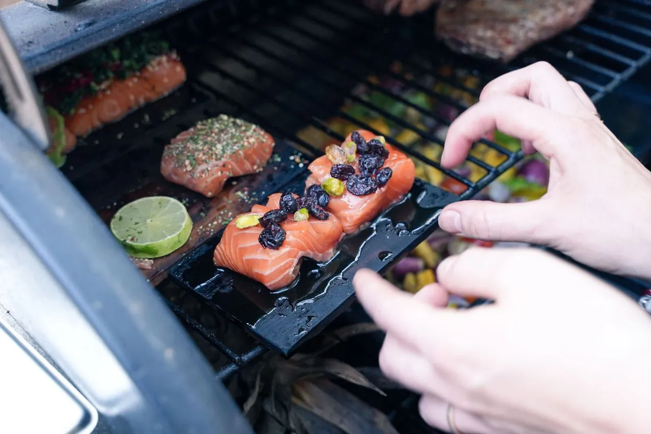 Salmon being glazed on the grill