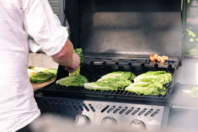 Romaine hearts grilling on a gas grill
