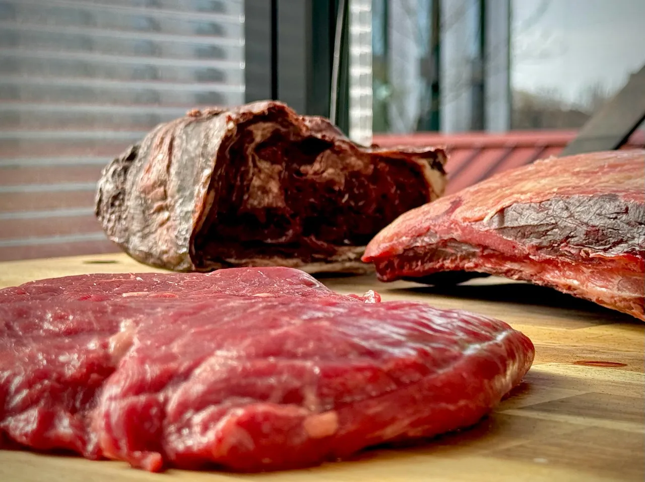 Raw beef steaks on a cutting board