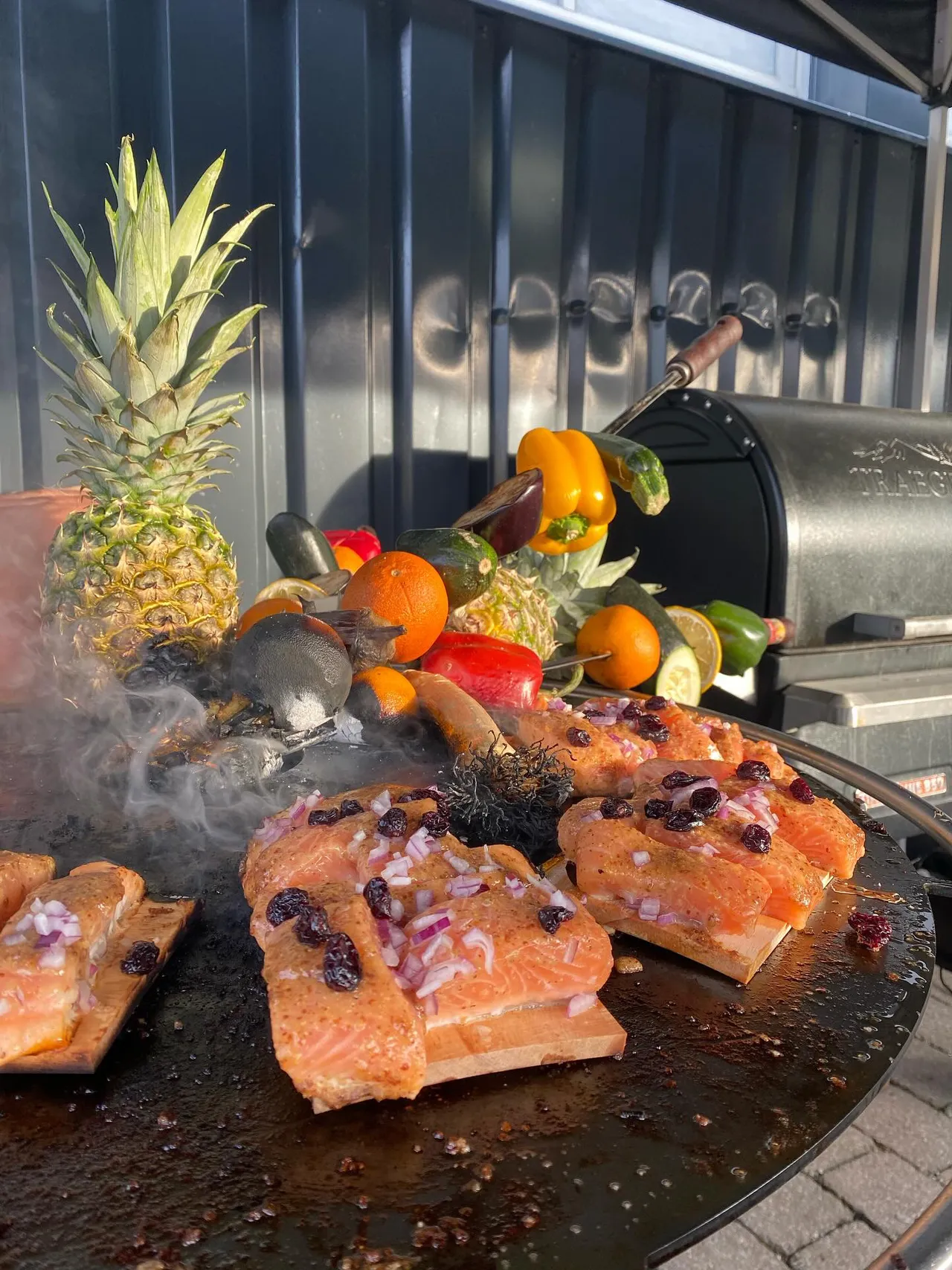 Salmon and fruit on a fire plate grill