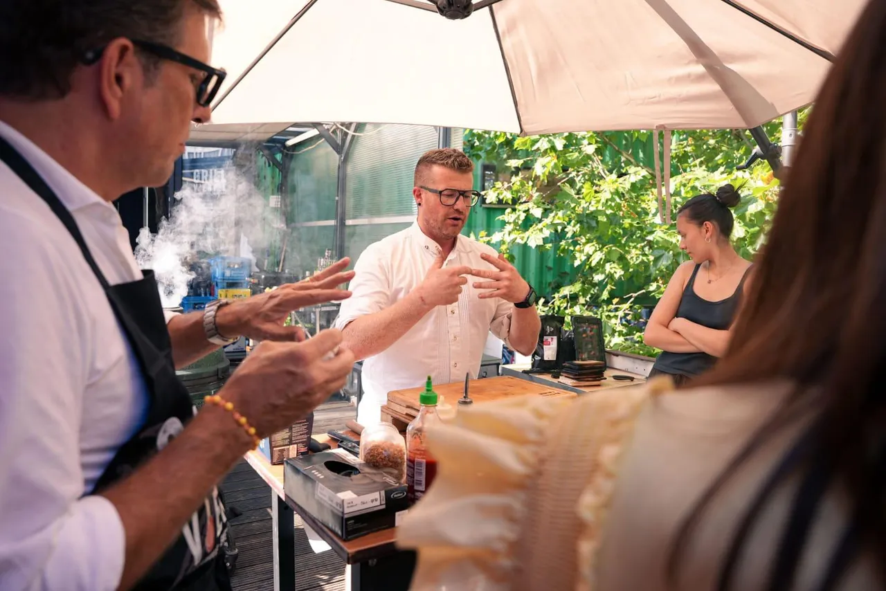 Grill master seasoning food at an outdoor grill