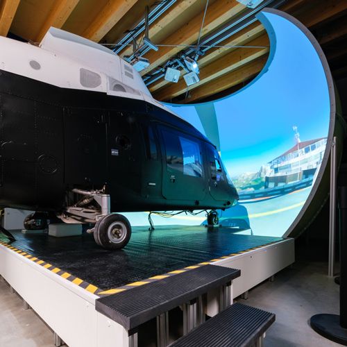 Agusta A109 helicopter simulator in front of a large curved projection dome