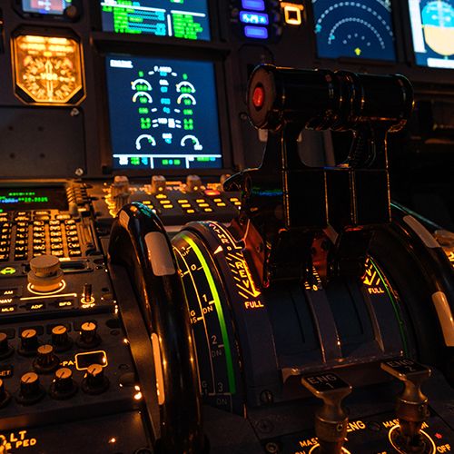 Close-up of the Airbus A320 simulator thrust levers and flight deck controls