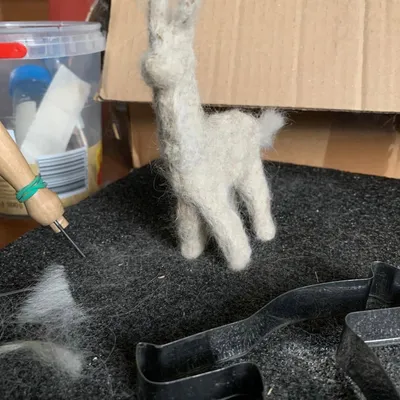An alpaca figurine made out of alpaca wool