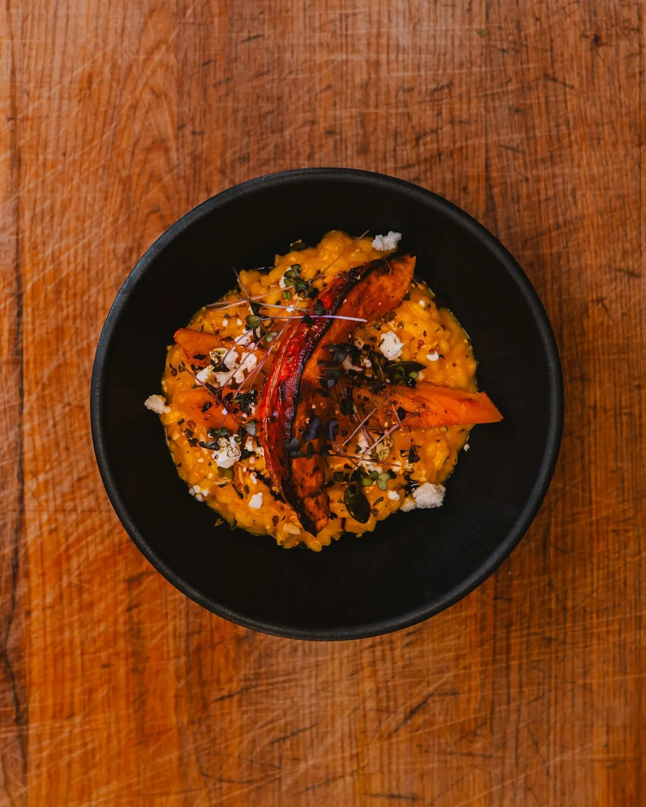 Asian street food dish with chili in a black bowl