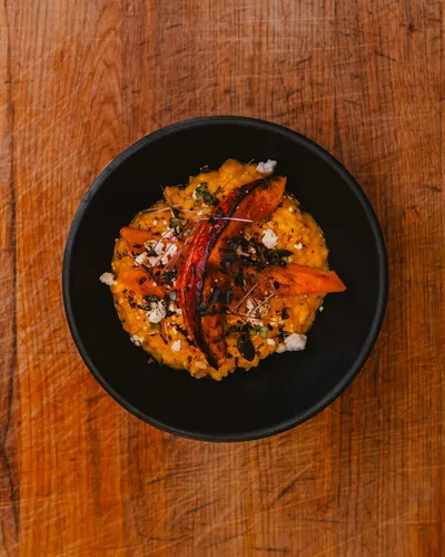 Asian street food dish with chili in a black bowl