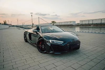 Audi R8 V10 convertible seen from the front left at sunset