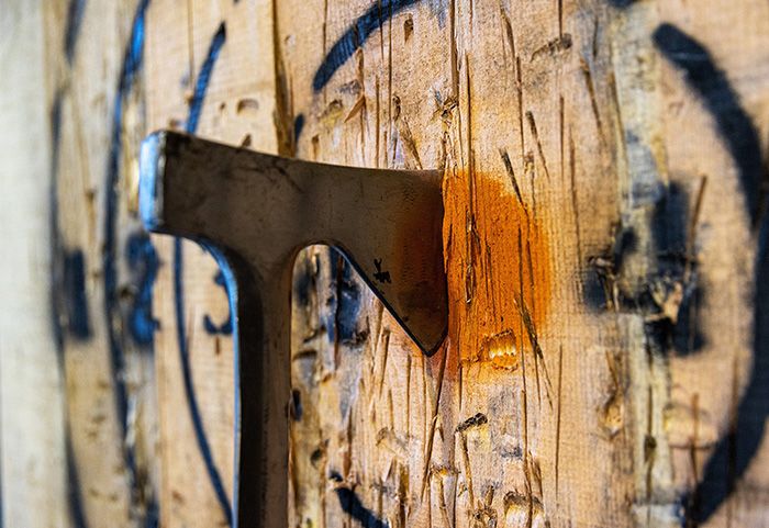 An axe in a wooden board
