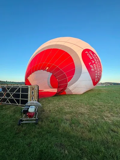 Balloon envelope being inflated on a meadow before takeoff