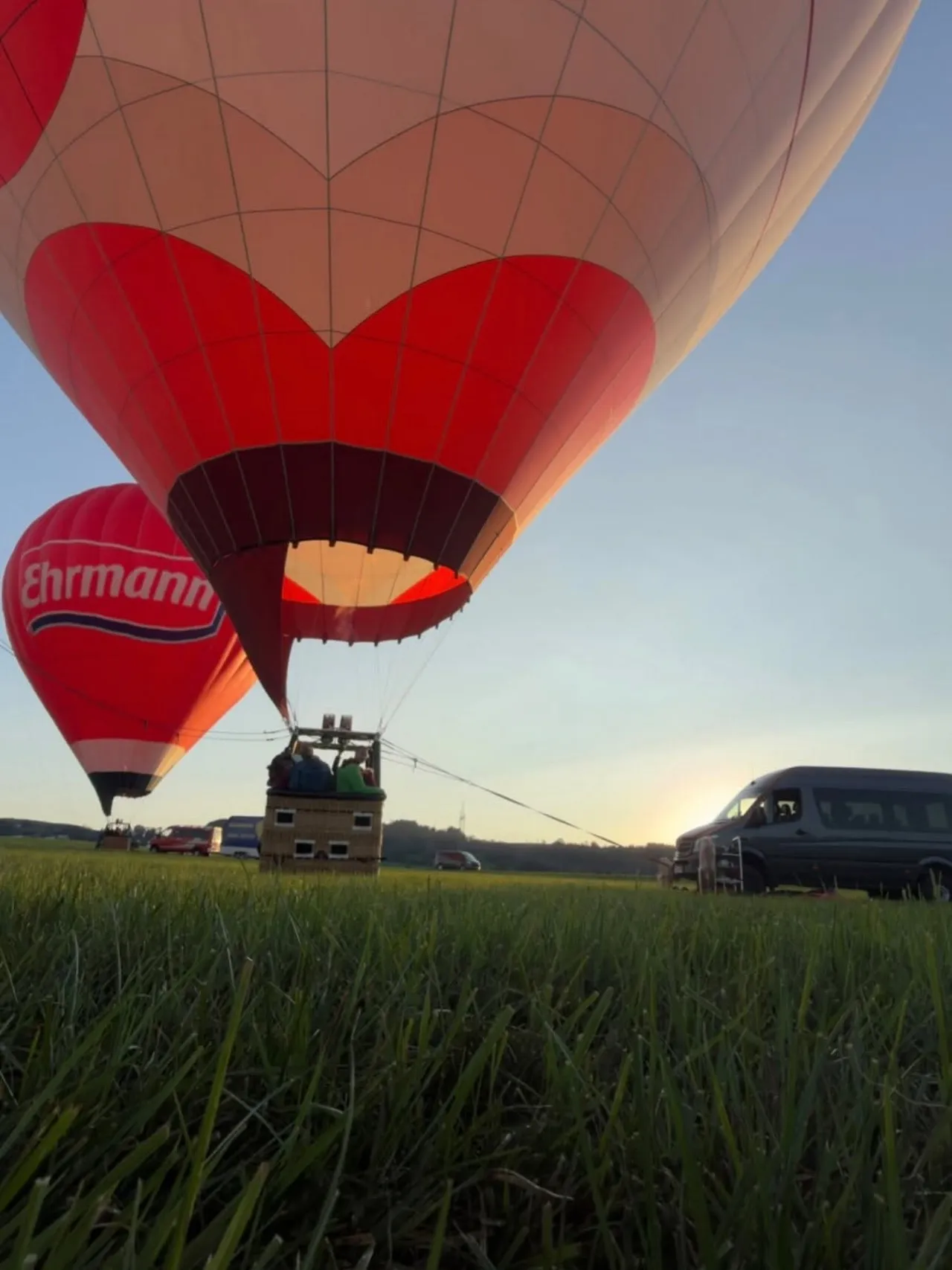 Hot air balloon on a meadow at sunrise