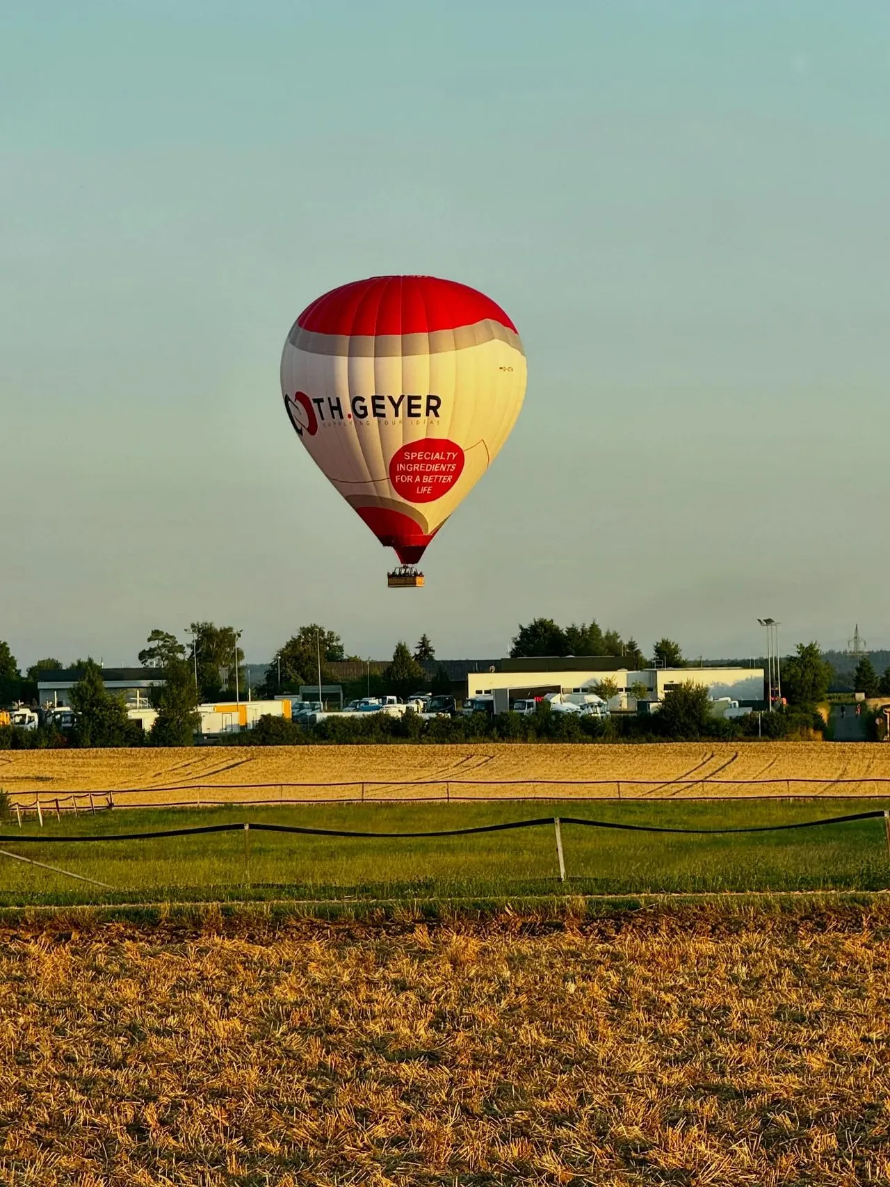Hot air balloon floating over a field