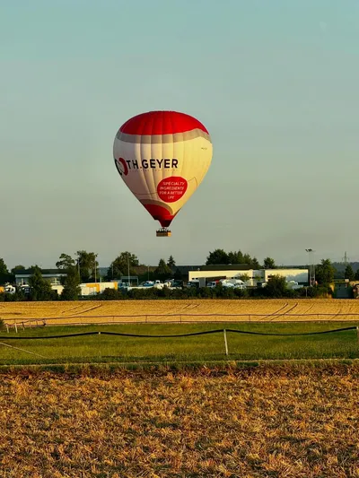 Hot air balloon floating over a field