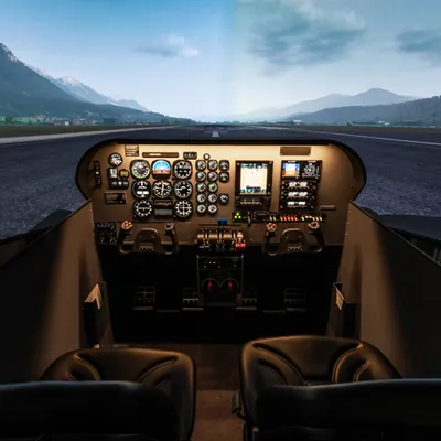 Beechcraft Baron 58 simulator cockpit facing a runway with mountains on the projection screen