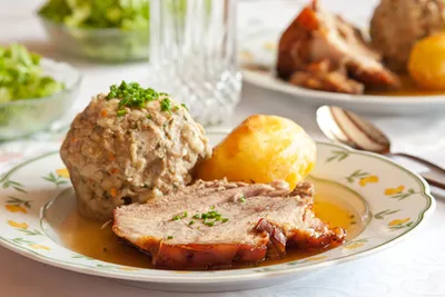 Bavarian roast pork with a bread dumpling, potato dumpling and gravy