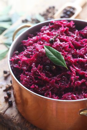 Braised red cabbage with bay leaf in a copper pot