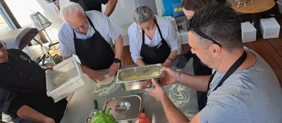 A group of people preparing pizza dough