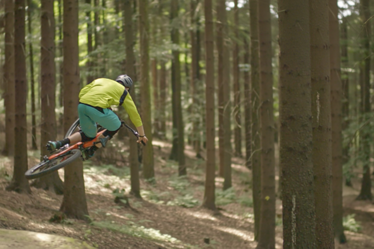 A person riding a mountain bike on a forest trail