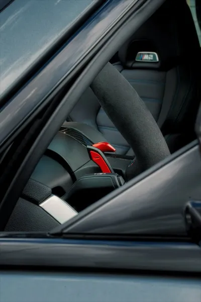 Interior detail of a BMW M2 Facelift 2026 with Alcantara steering wheel and M carbon bucket seat