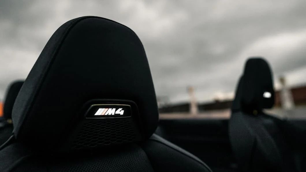 Illuminated M4 logo on the headrest of the BMW M4 Convertible