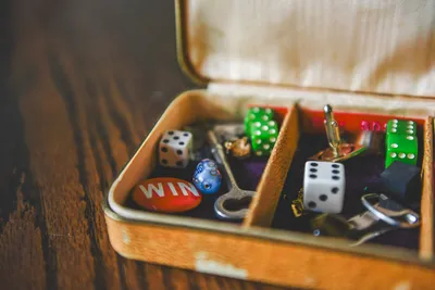 Small vintage box filled with dice, old keys and trinkets