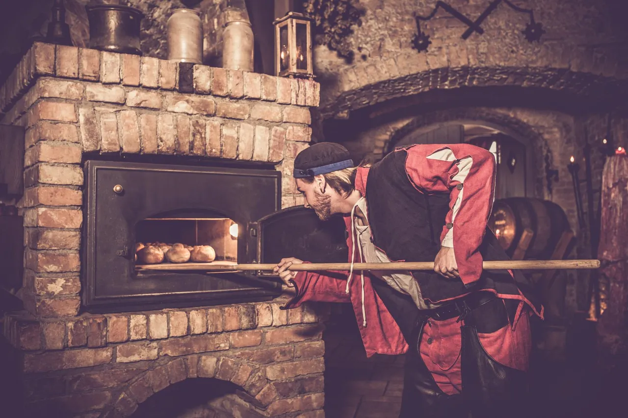 Servant taking freshly baked bread out of the stone oven