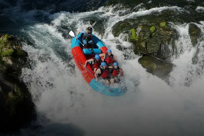 Adventure & sports experiences: team whitewater rafting through rapids