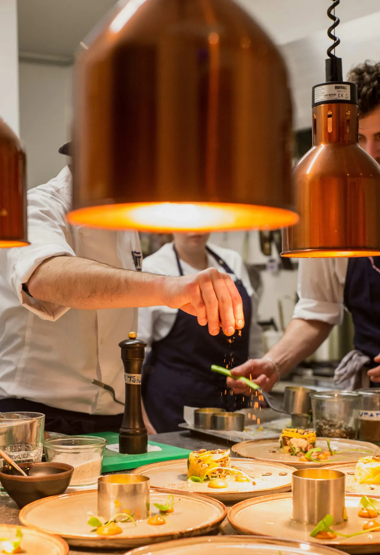 A group of people preparing a gourmet dish