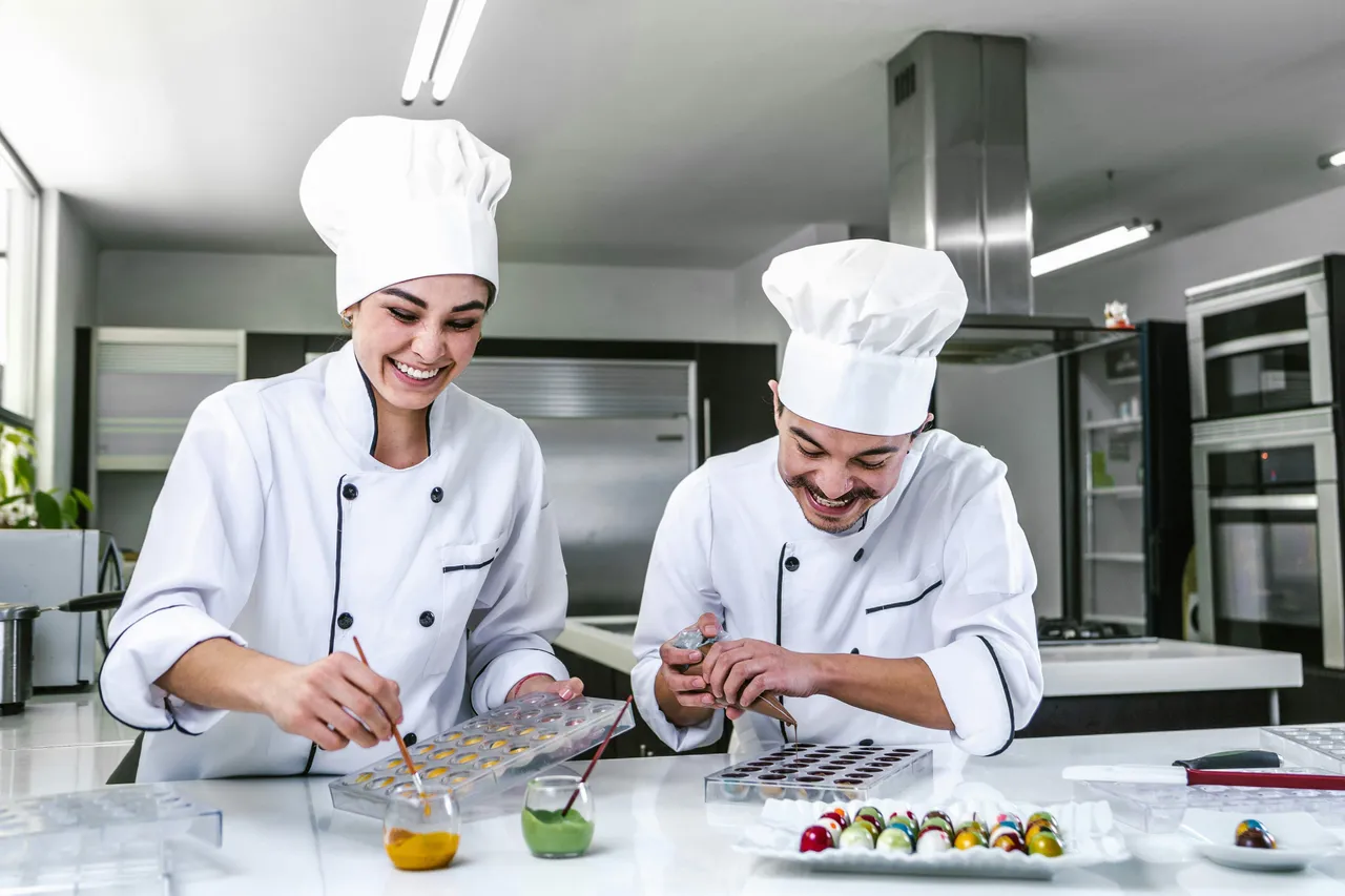 Two chefs perparing pralines