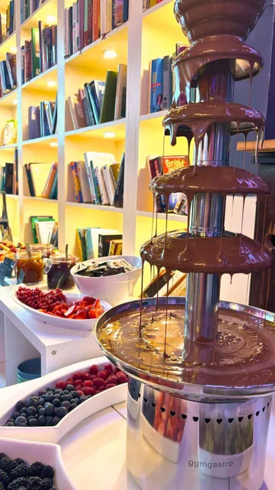 Chocolate fountain with melted chocolate flowing down the sides