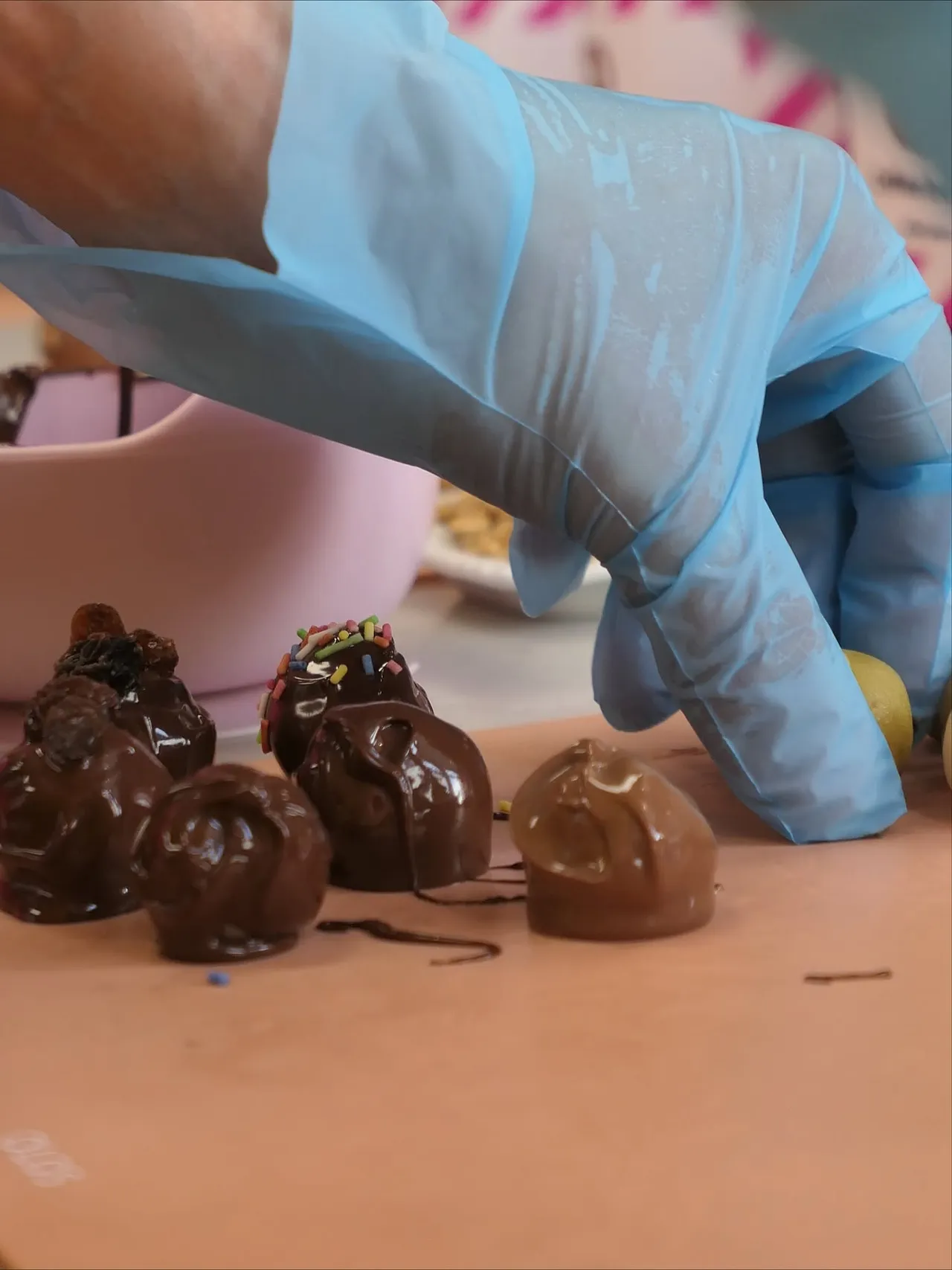 Chocolates being coated with chocolate