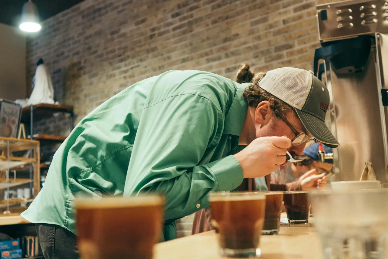 A person tasting different coffees