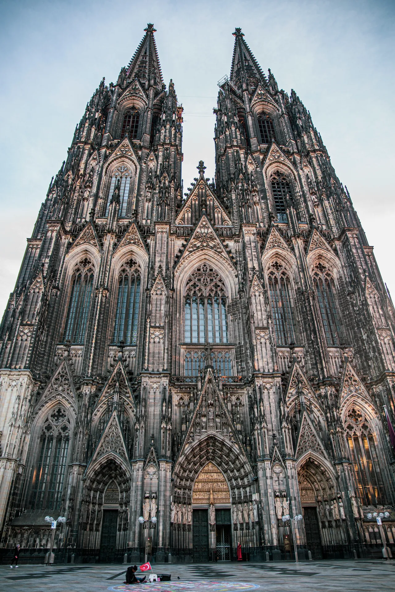 Low-angle view of Cologne Cathedral's Gothic facade and twin spires against the sky