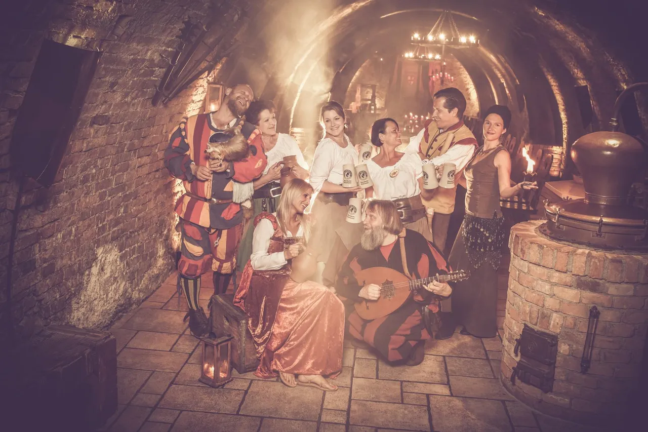Cupbearer, maids, servants and performers in costume in the vaulted cellar