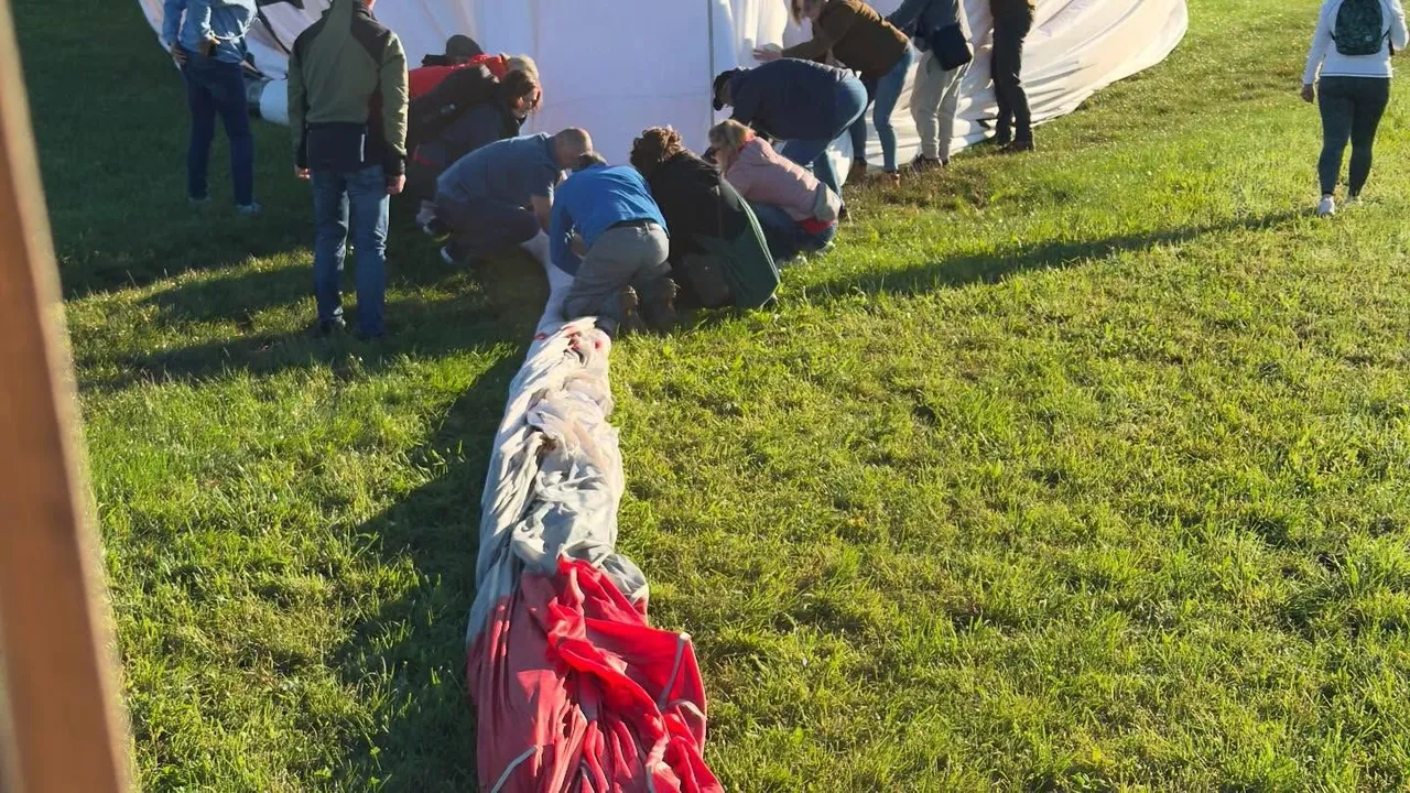 Crew laying out the balloon envelope on the grass