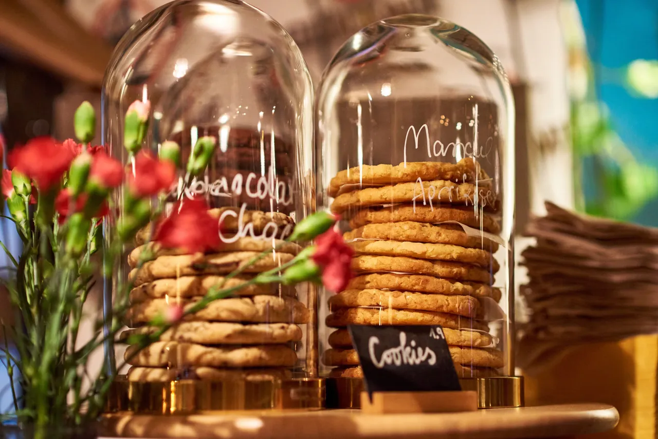 Stacks of homemade cookies in glass jars with red flowers