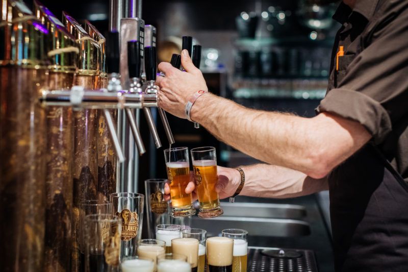 Bartender pouring fresh beers from the tap