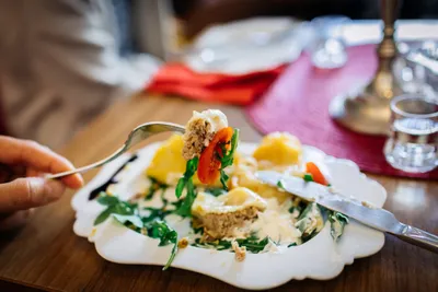 Guest eating a colourful plated dish at a restaurant table