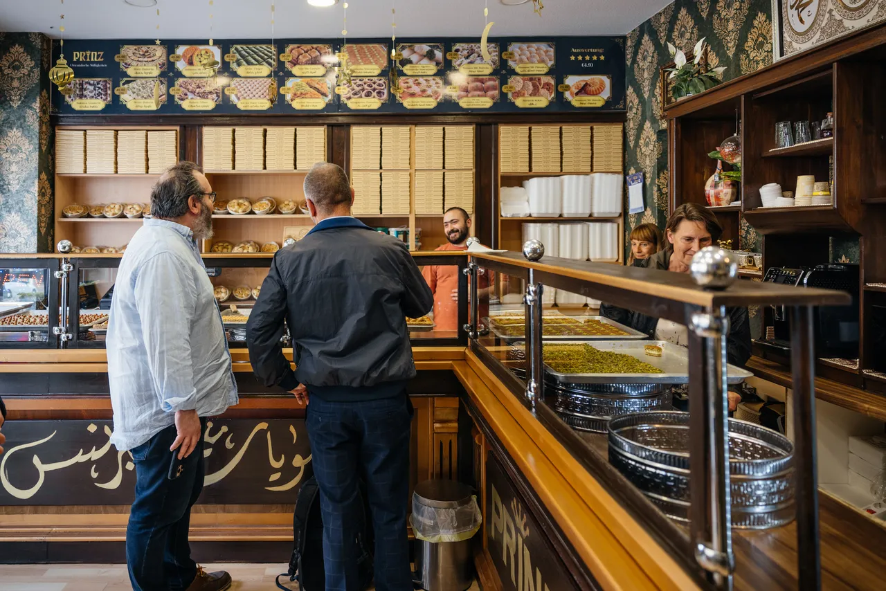 Tour guests at the counter of an oriental sweets shop