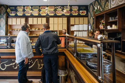 Tour guests at the counter of an oriental sweets shop