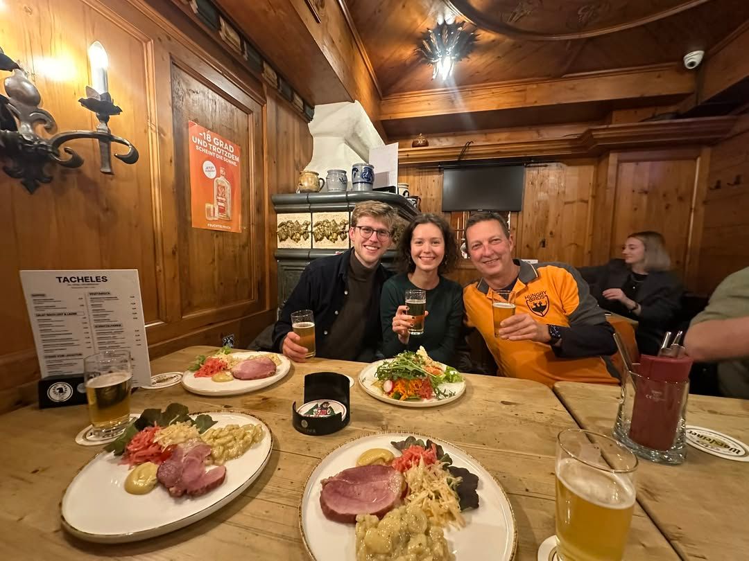 Three people sitting at a table during a culinary tour
