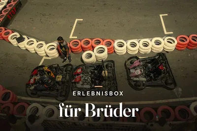 Experience gift box for brothers – aerial view of go-karts lined up on a track with red and white tyre barriers