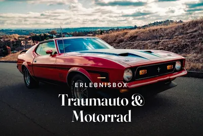 Red classic Ford Mustang with a black hood stripe parked on a hilltop road, with autumn hills and a cloudy sky behind it, with the text “Erlebnisbox – Traumauto & Motorrad”