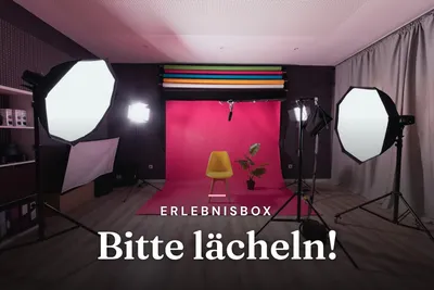 Photo studio with softbox lights, yellow chair and pink backdrop