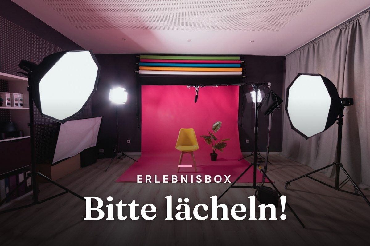 Photo studio with softbox lights, yellow chair and pink backdrop
