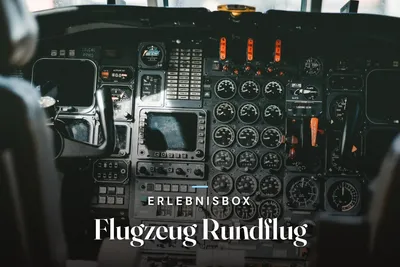 Cockpit of a small aircraft with an instrument panel full of round gauges, switches and red fire handles, with the text “Erlebnisbox – Flugzeug Rundflug”