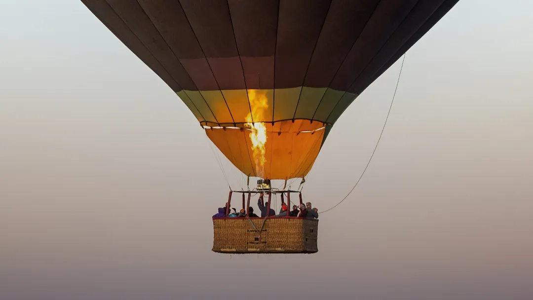 A hot air balloon flying in the evening sky