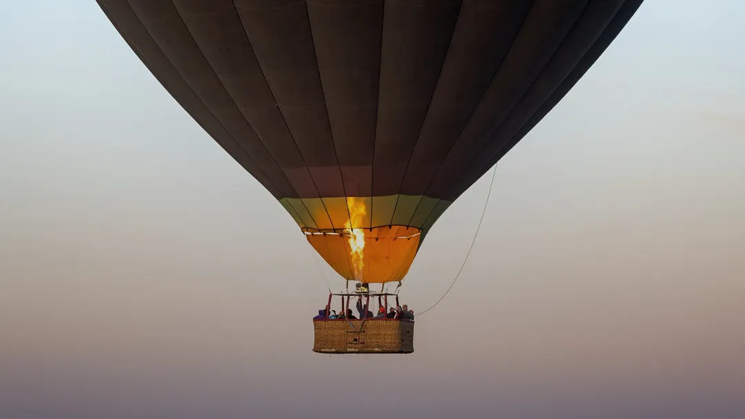 A hot air balloon flying in the evening sky