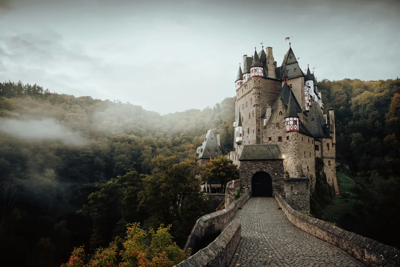 Fairytale castle rising out of a wooded valley