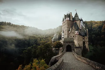Fairytale castle rising out of a wooded valley