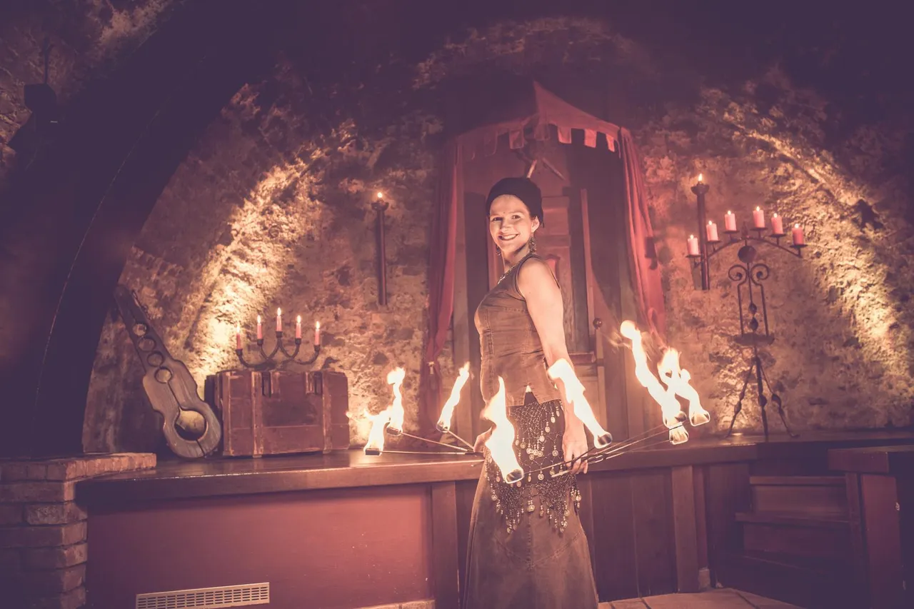 Fire show performance in the medieval vaulted cellar